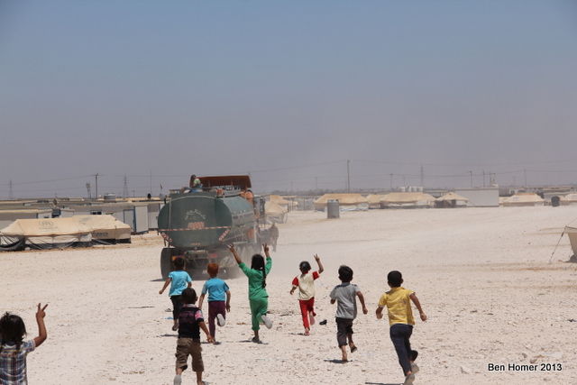 Children chase after a water truck. More than a million litres of water are delivered to the camp per day by trucks which are constantly in motion throughout the camp. While the UN and other NGOs have begun to build capacity for schooling, there is little for kids in the camp to do.  