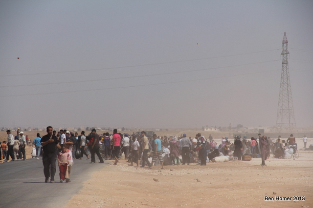 Refugees wait for buses to make the return trip to Syria. Each day several hundred people return from Za’atari to Syria.