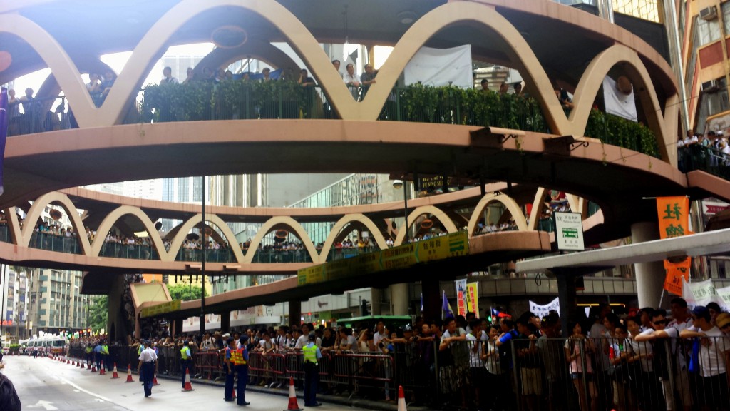 Throngs of protesters line Hennessy Road and overpass in Central Hong Kong moments before tensions caused for momentary friction between demonstrators and police officers at the July 1st March.